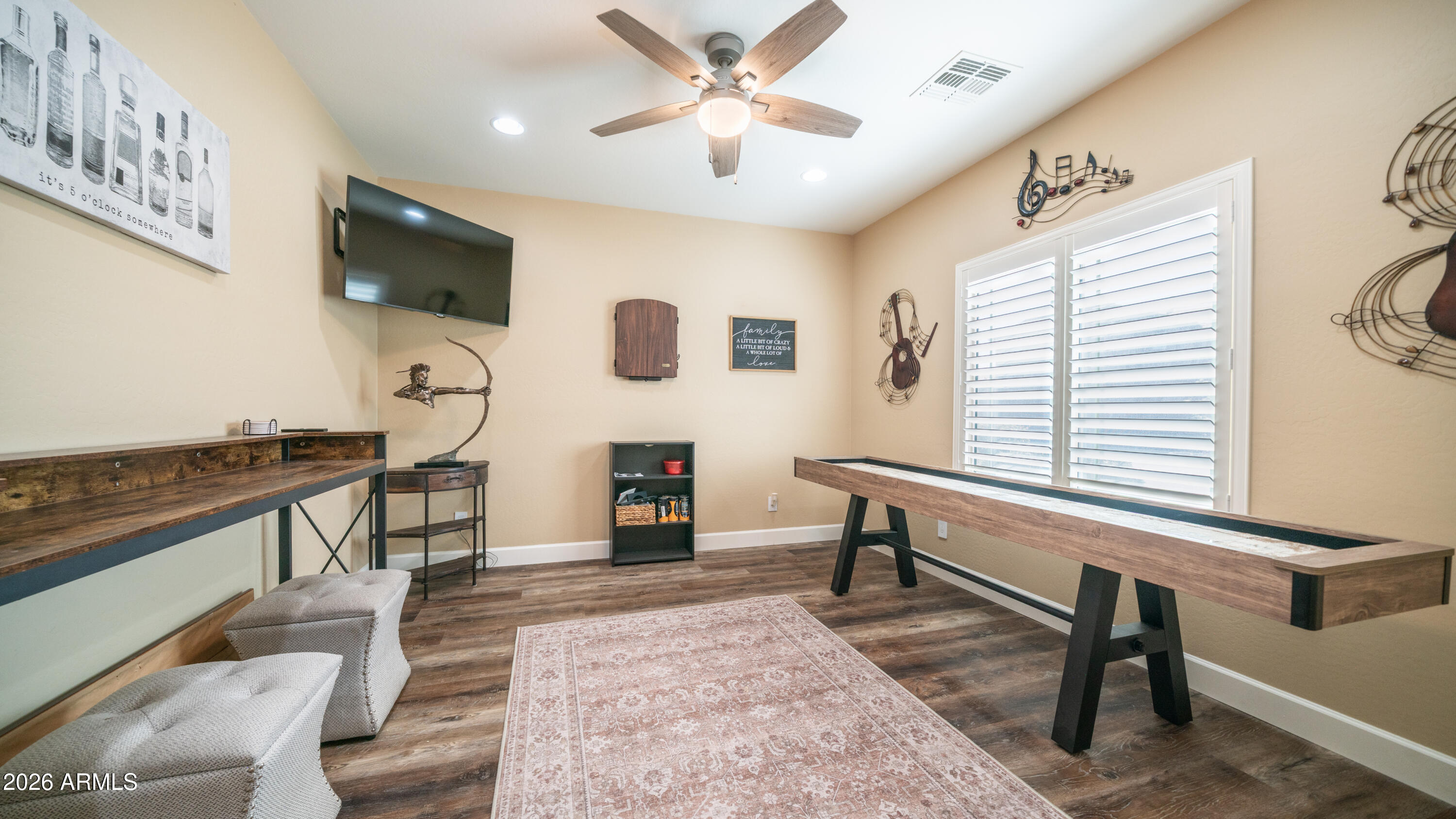 10754 West Yearling Road Peoria, AZ 85383 - Photo 2 of 35 a living room with furniture and a flat screen tv