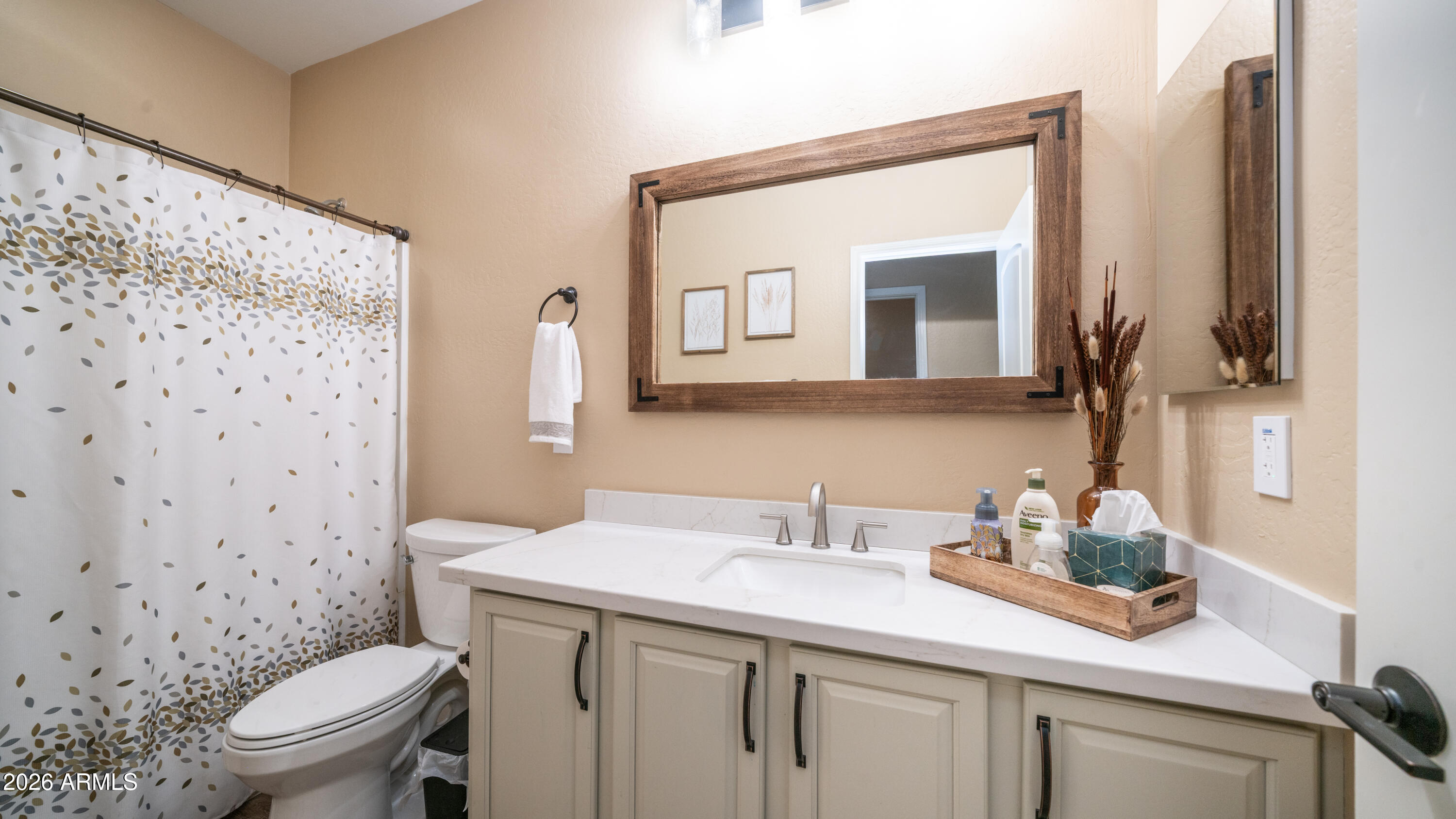 10754 West Yearling Road Peoria, AZ 85383 - Photo 25 of 35 a bathroom with a sink a toilet and a mirror