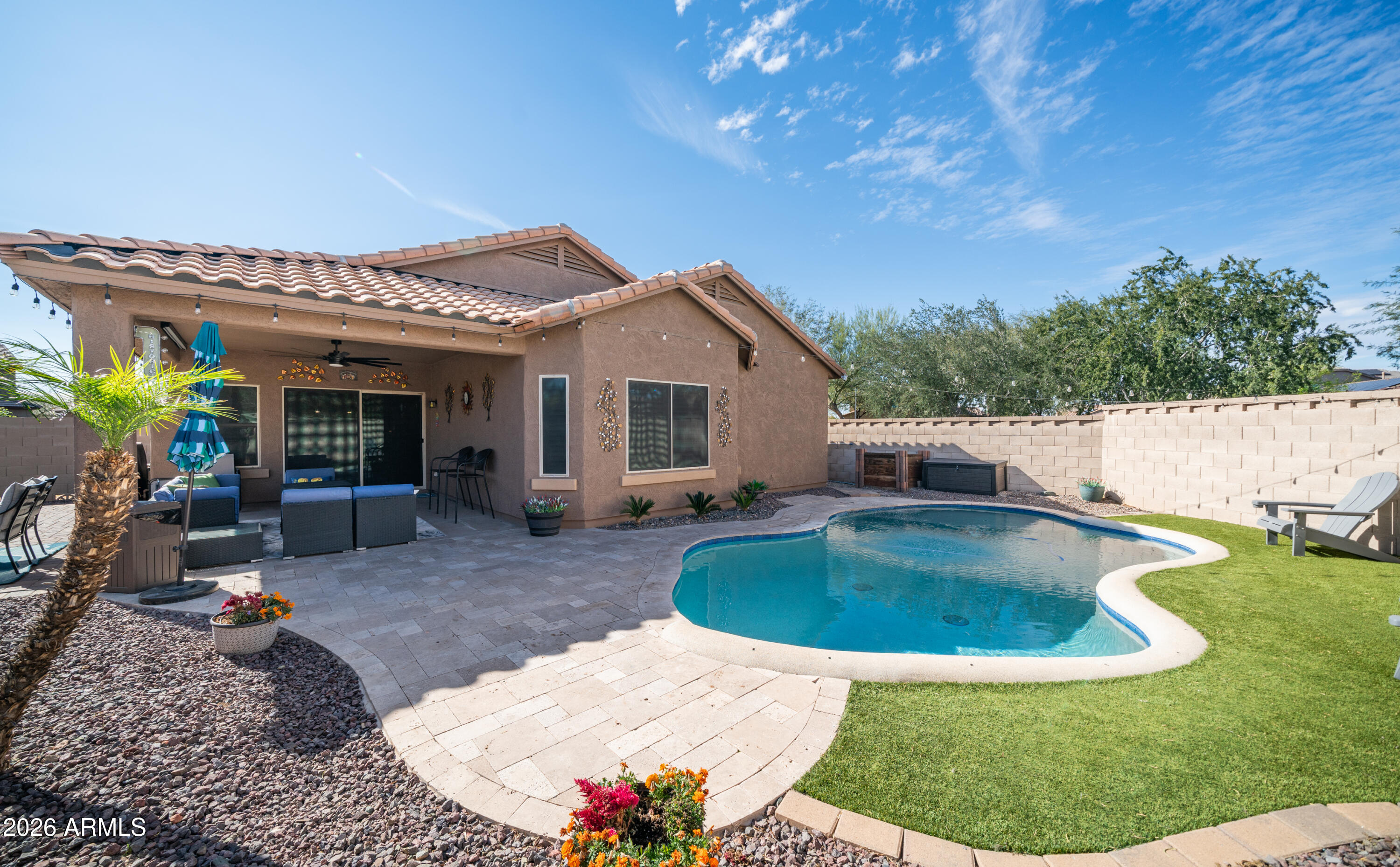 10754 West Yearling Road Peoria, AZ 85383 - Photo 27 of 35 a view of a house with backyard sitting area and garden