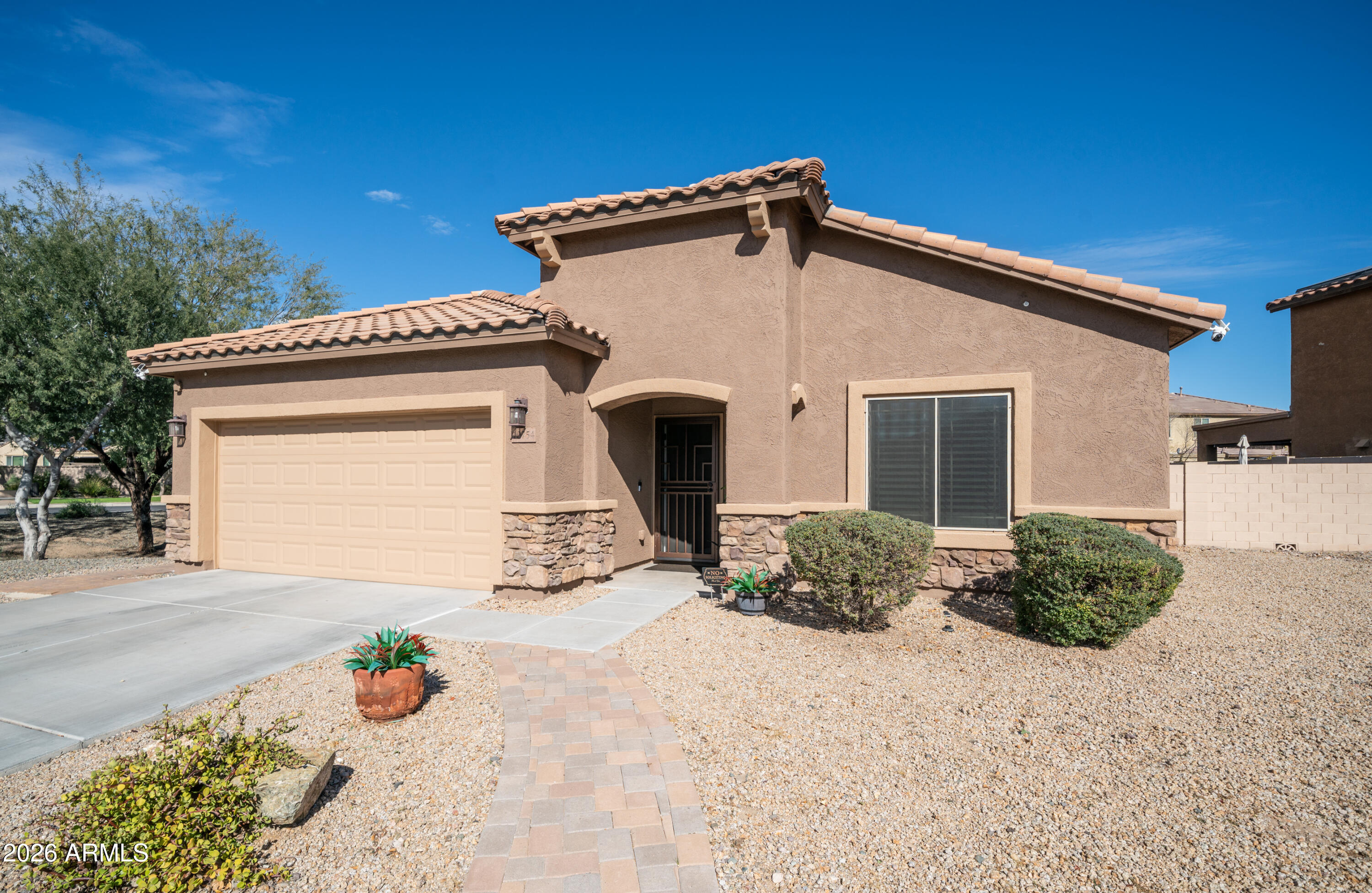10754 West Yearling Road Peoria, AZ 85383 - Photo 35 of 35 a view of a house with a yard and potted plants