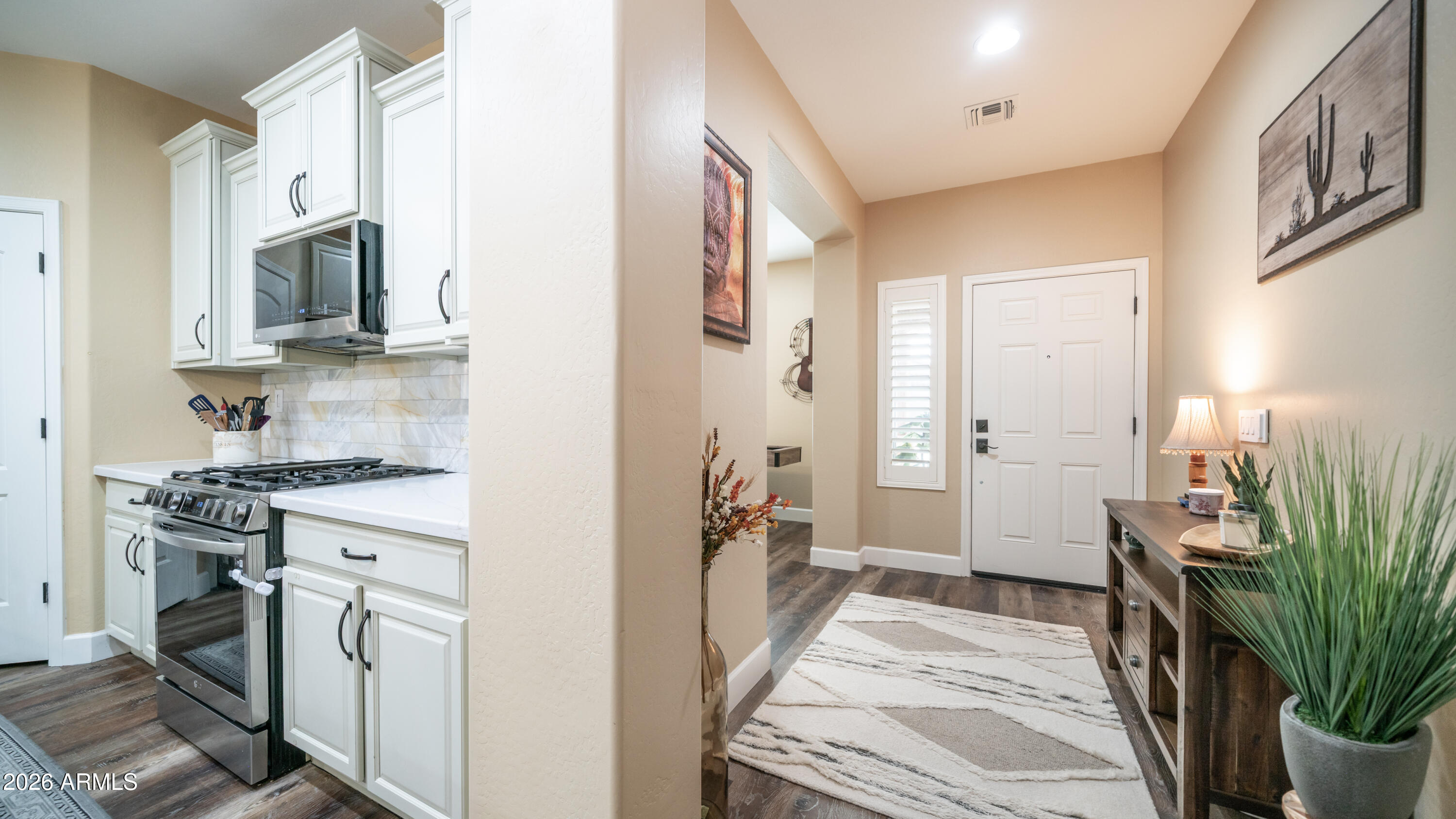 10754 West Yearling Road Peoria, AZ 85383 - Photo 4 of 35 a kitchen with white cabinets and a stove top oven