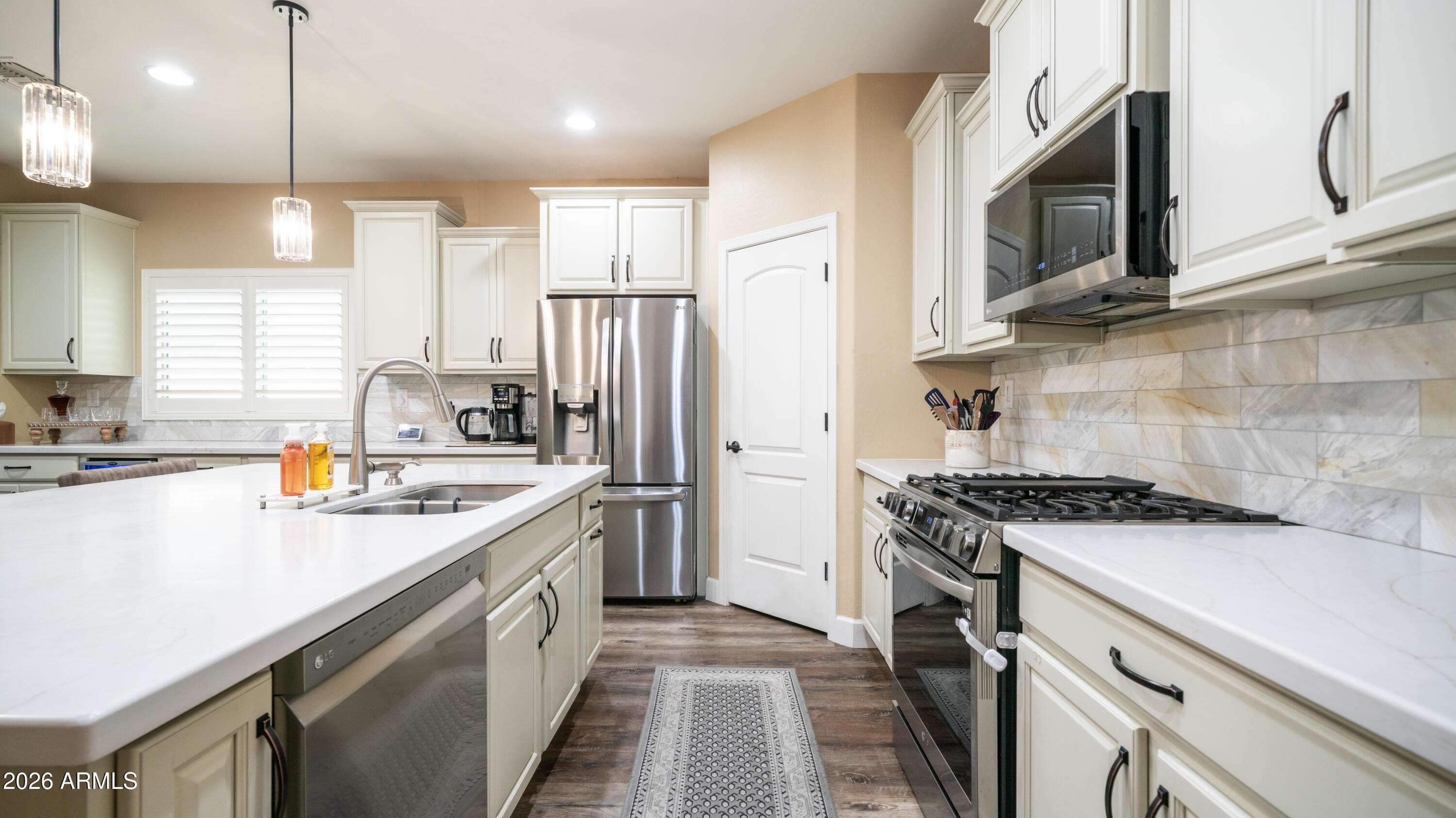10754 West Yearling Road Peoria, AZ 85383 - Photo 5 of 35 a kitchen with stainless steel appliances granite countertop a sink a stove and a refrigerator