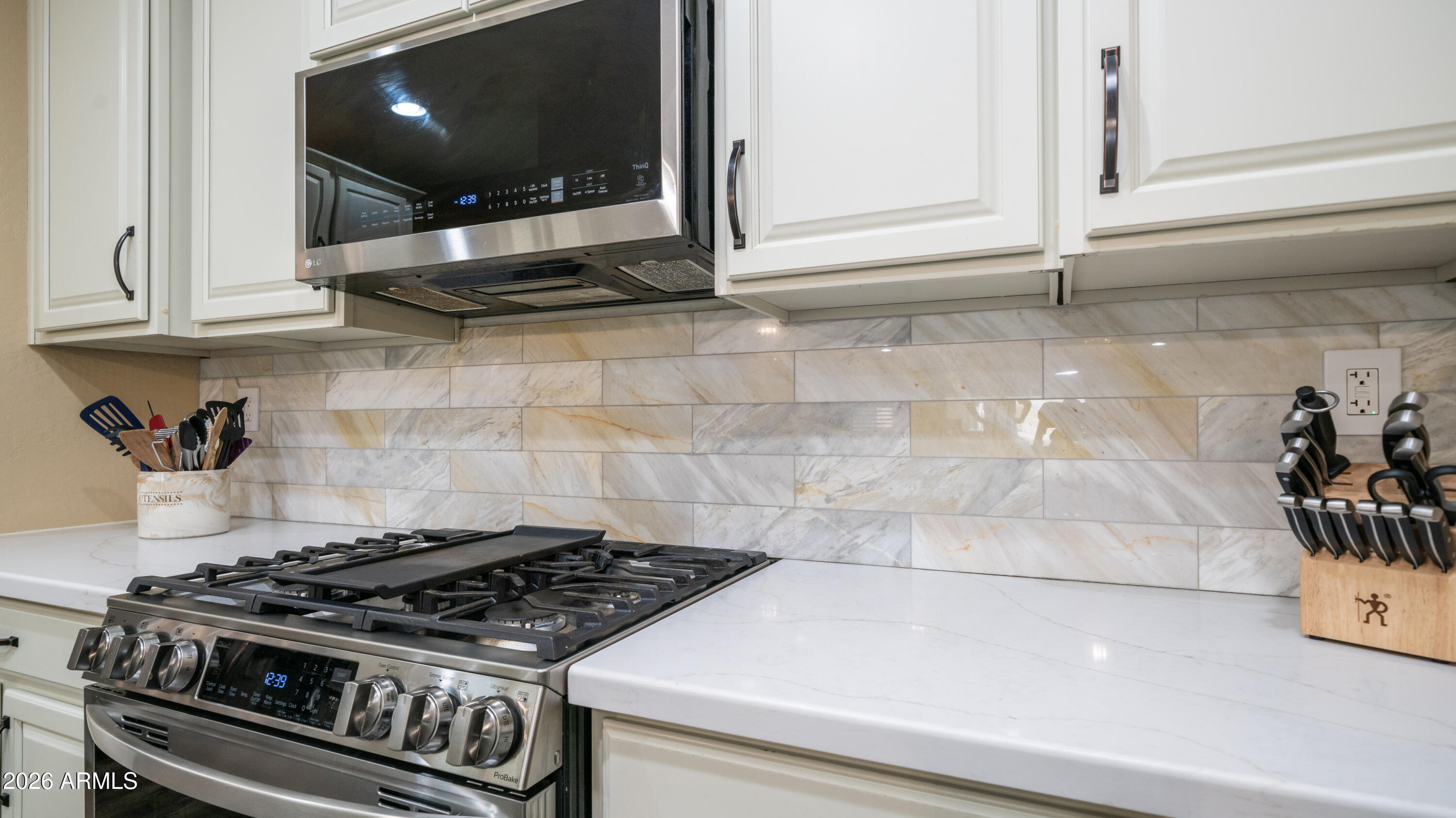 10754 West Yearling Road Peoria, AZ 85383 - Photo 6 of 35 a stove top oven sitting inside of a kitchen