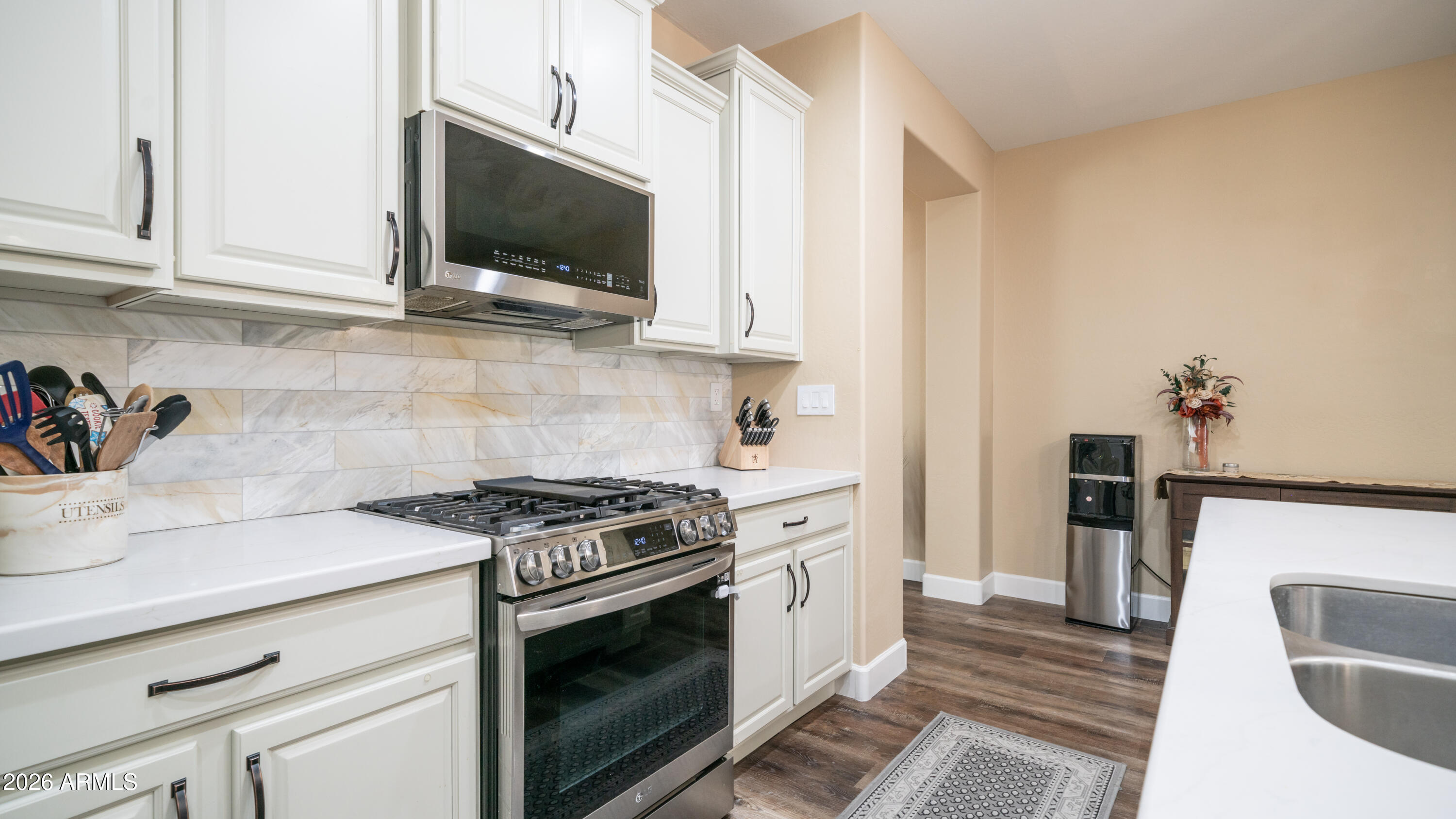 10754 West Yearling Road Peoria, AZ 85383 - Photo 7 of 35 a kitchen with stainless steel appliances a stove a microwave and sink