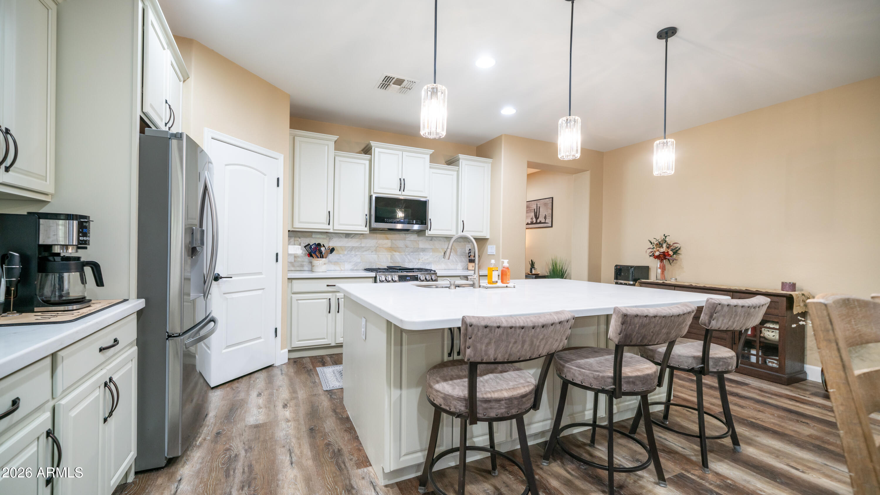 10754 West Yearling Road Peoria, AZ 85383 - Photo 8 of 35 a kitchen with a table chairs refrigerator and microwave
