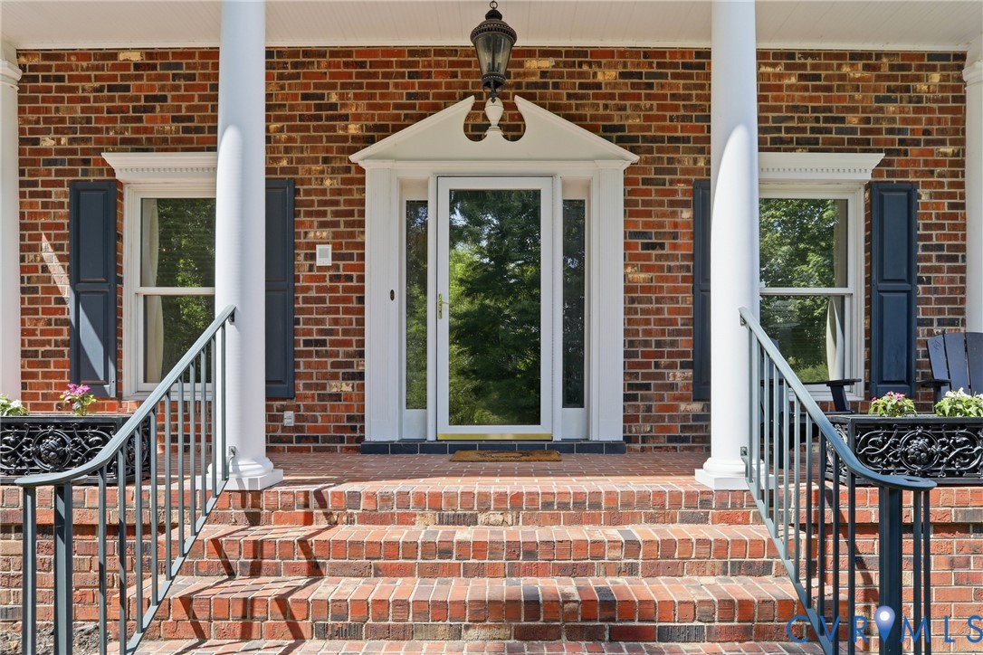 13300 West Patrick Henry Road Doswell, VA 23047 - Photo 45 of 69 Brick facade featuring a columned front porch with