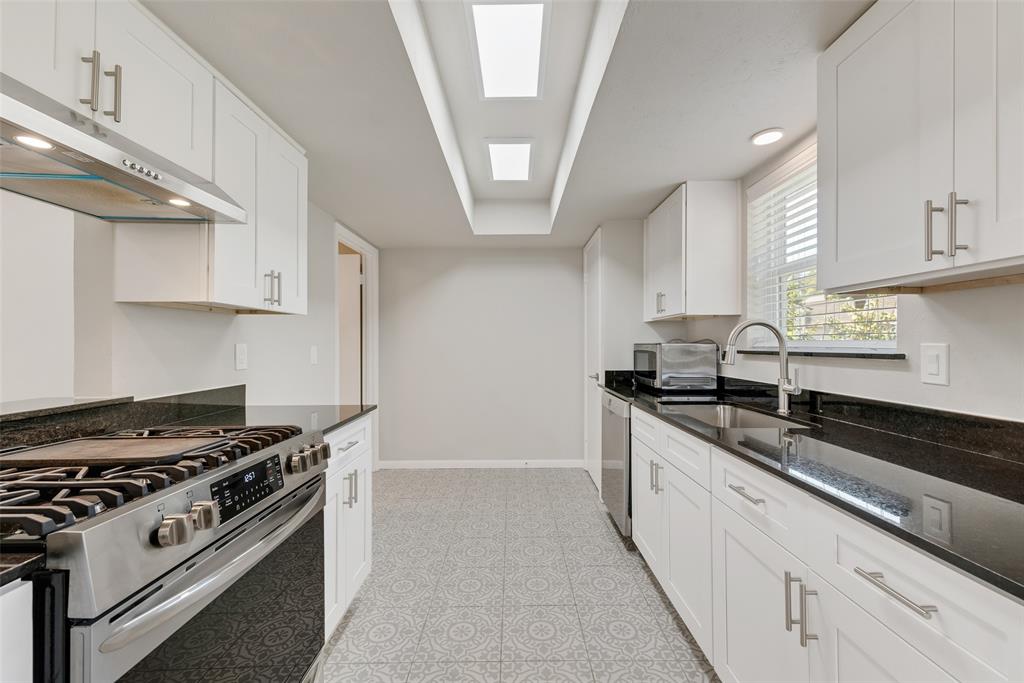 4010 Burning Tree Lane Garland, TX 75042 - Photo 11 of 20 a large kitchen with stainless steel appliances granite countertop a stove and a sink