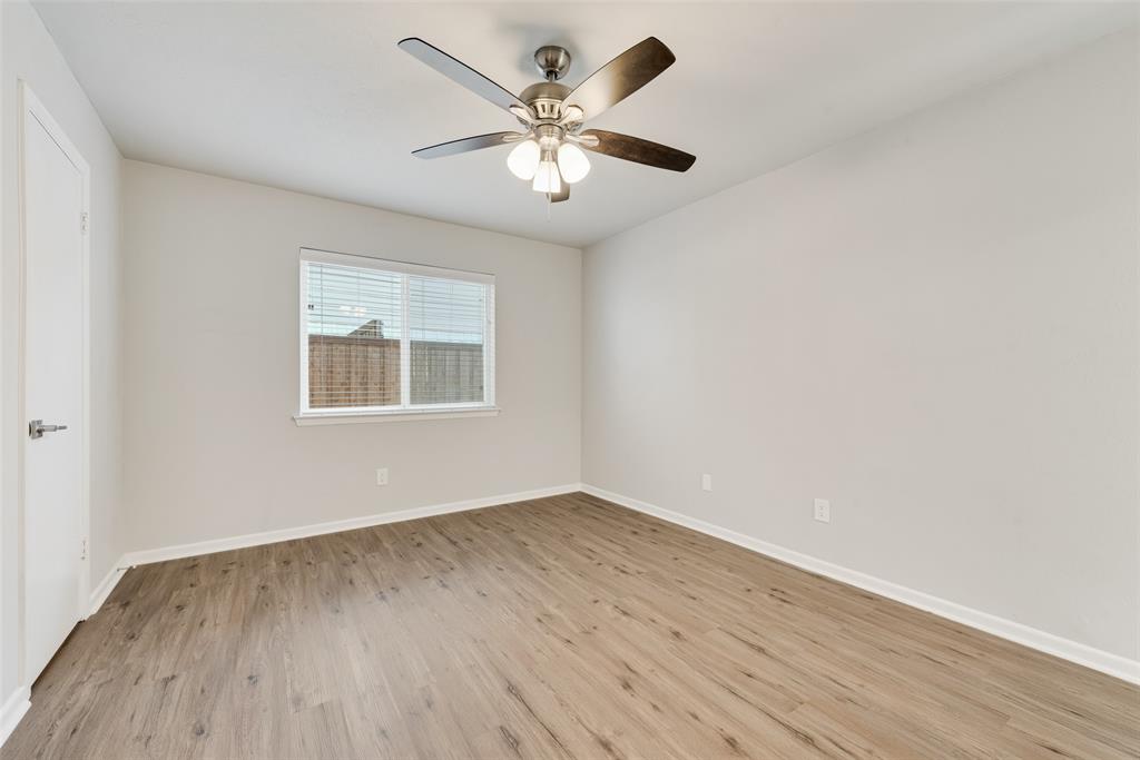 4010 Burning Tree Lane Garland, TX 75042 - Photo 12 of 20 wooden floor in an empty room with a window