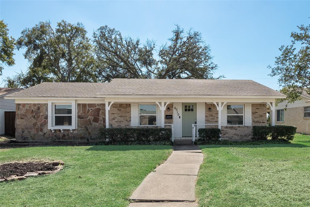 4010 Burning Tree Lane Garland, TX 75042 - Photo 2 of 20 a front view of a house with a garden and plants