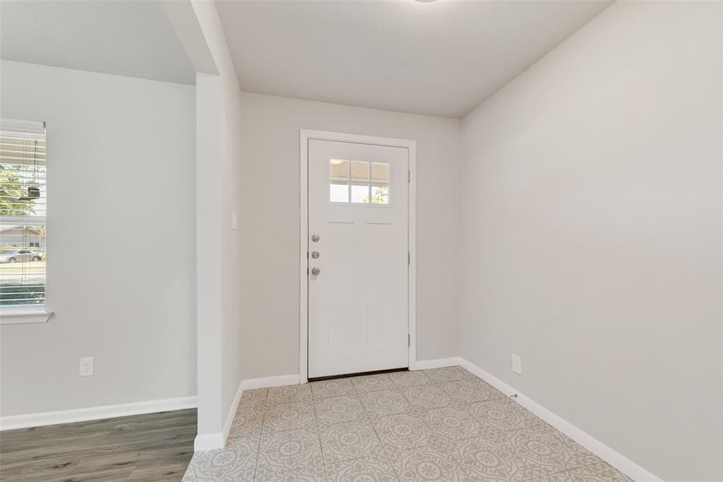 4010 Burning Tree Lane Garland, TX 75042 - Photo 3 of 20 a view of an empty room with wooden floor and a window