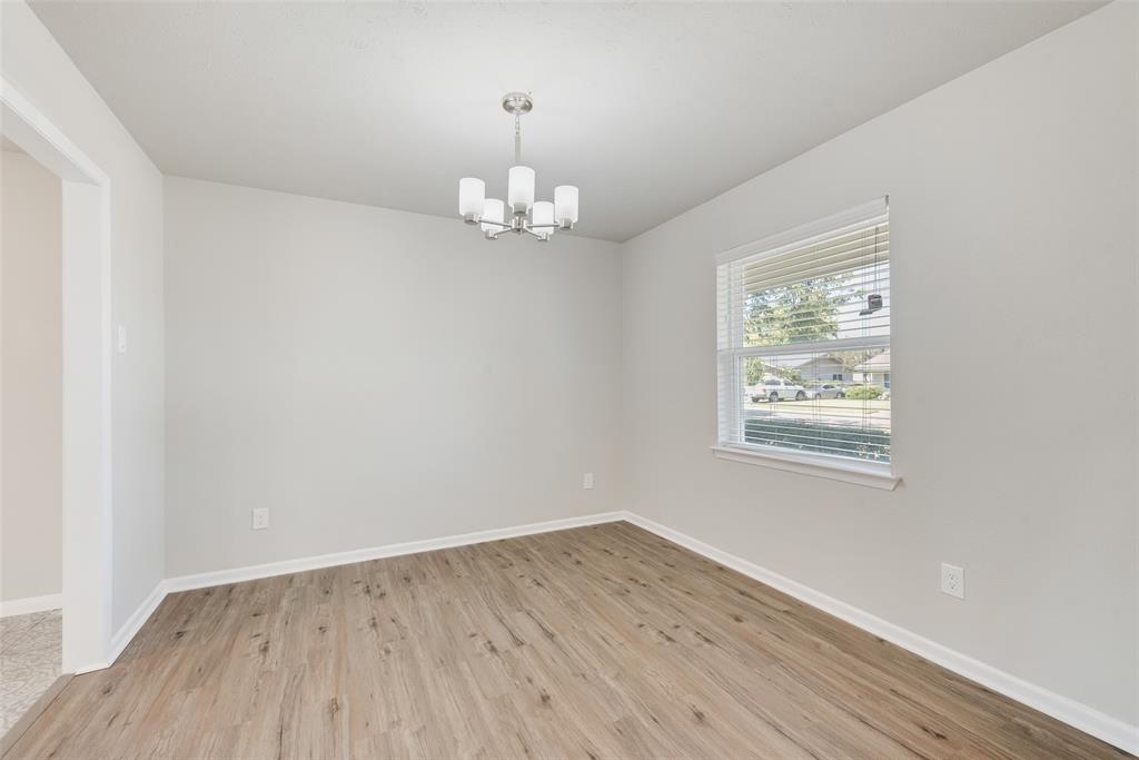 4010 Burning Tree Lane Garland, TX 75042 - Photo 4 of 20 wooden floor in an empty room with a window