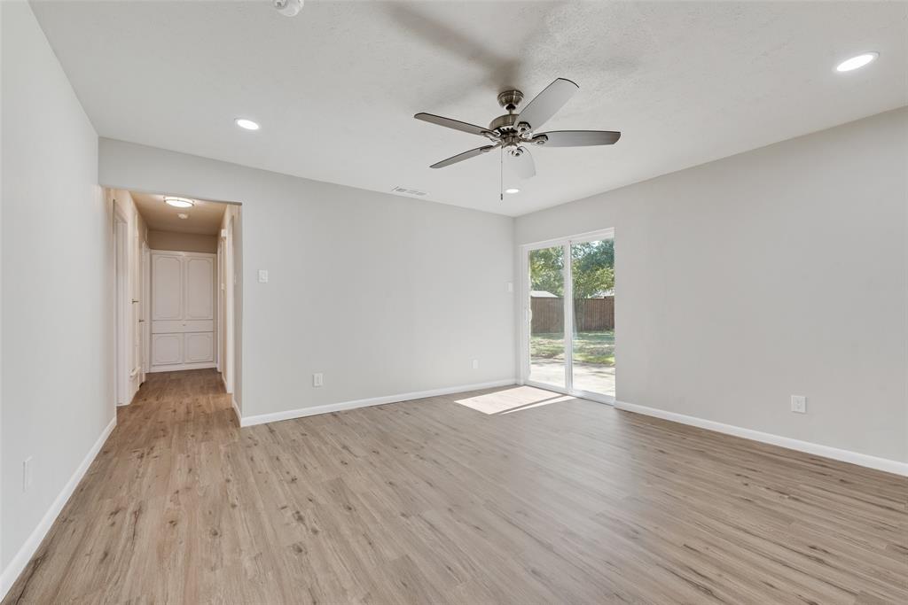 4010 Burning Tree Lane Garland, TX 75042 - Photo 5 of 20 a view of an empty room with wooden floor and a window