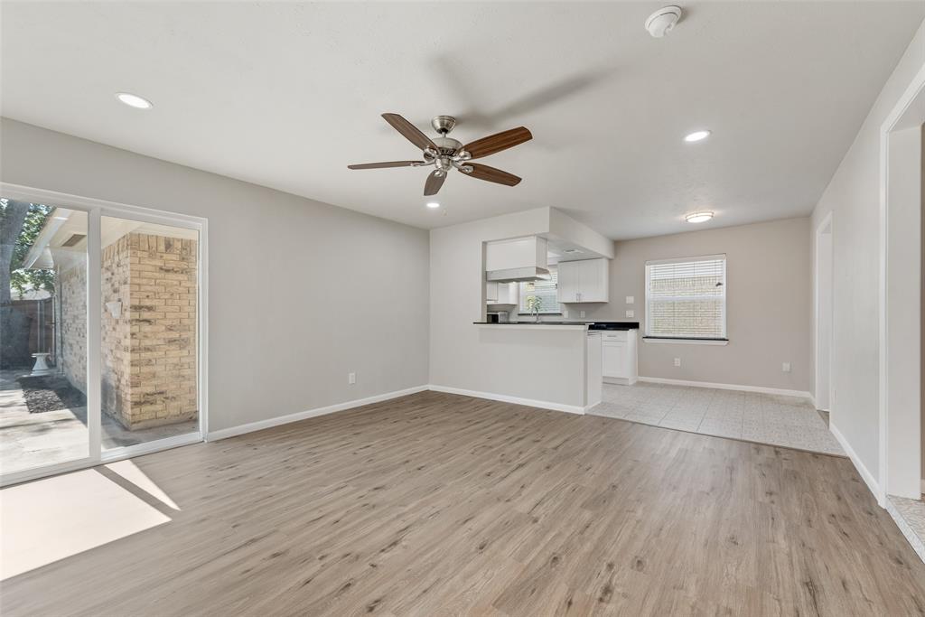4010 Burning Tree Lane Garland, TX 75042 - Photo 7 of 20 a view of a kitchen with wooden floor and a kitchen