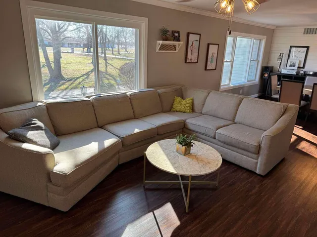 a living room with fireplace furniture and a flat screen tv