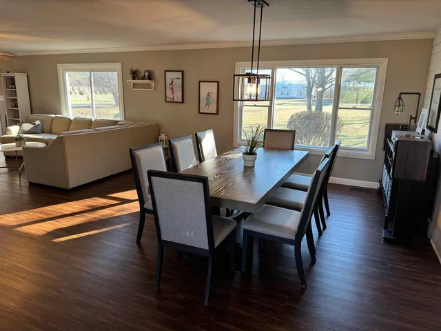 a view of a dining room with furniture window and outside view