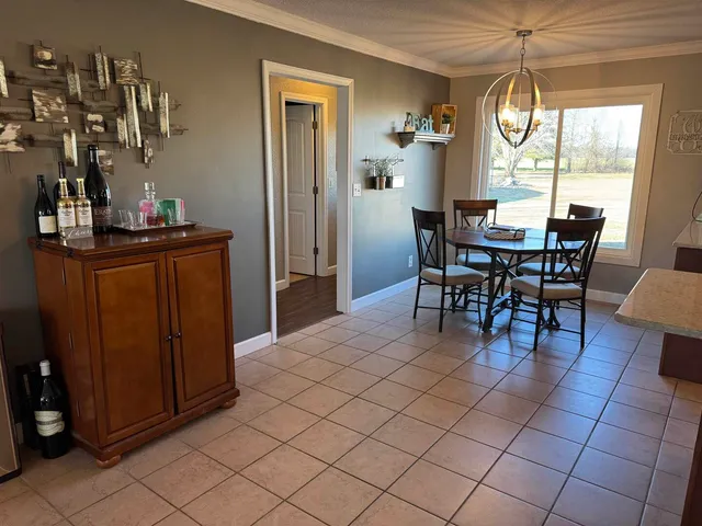 a dining room with furniture and window