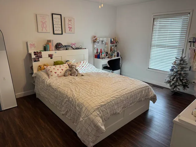 a bedroom with a bed and a white wall