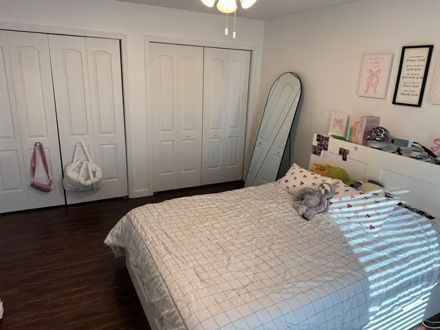 a bedroom with a bed and a closet