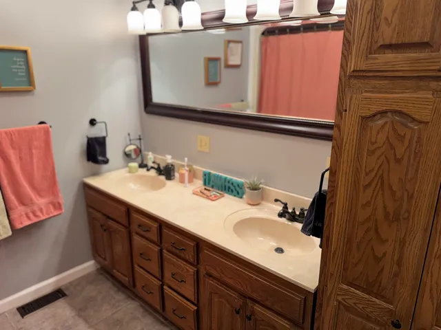 a bed sitting in a bedroom next to a window with wooden floor