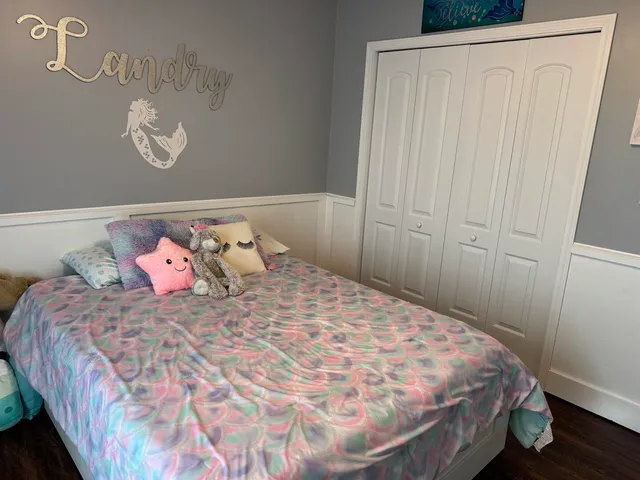 a bedroom with a bed and a dresser