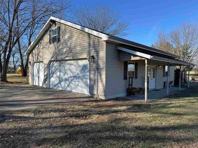 an empty room with wooden floor and closet