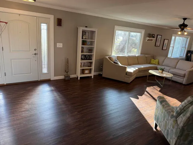 a living room with furniture and a fireplace