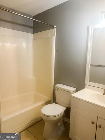 a bathroom with a toilet and a bathtub