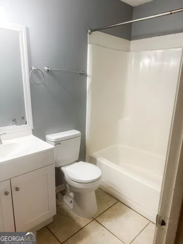a bathroom with a toilet and a bathtub