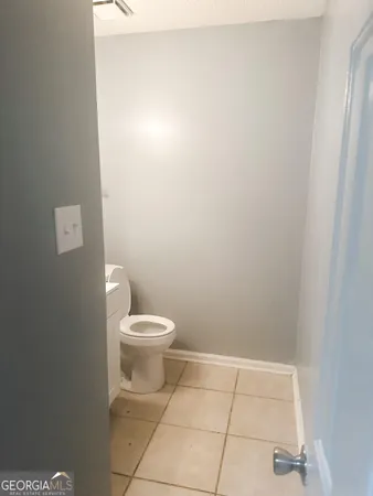 a white toilet sitting next to a white sink