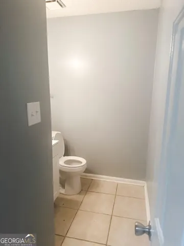 a white toilet sitting next to a white sink