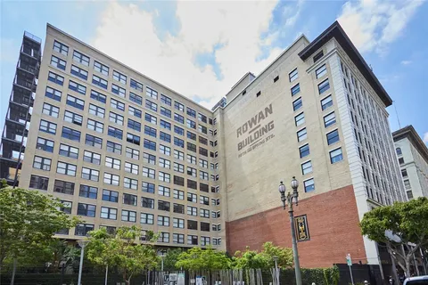 a view of a patio with table and chairs potted plants and large tree
