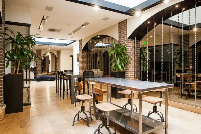 a living room with couches a fireplace with wooden floor