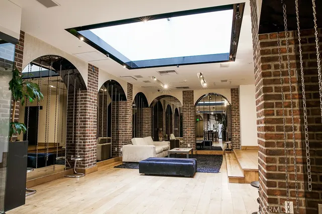 a view of a pathway with plants and large trees