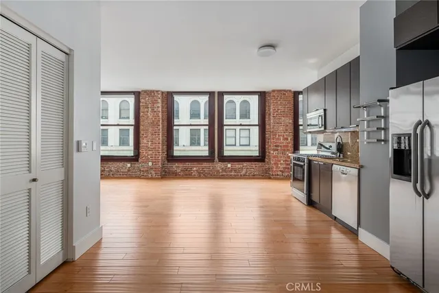a large kitchen with a large window a refrigerator and a sink