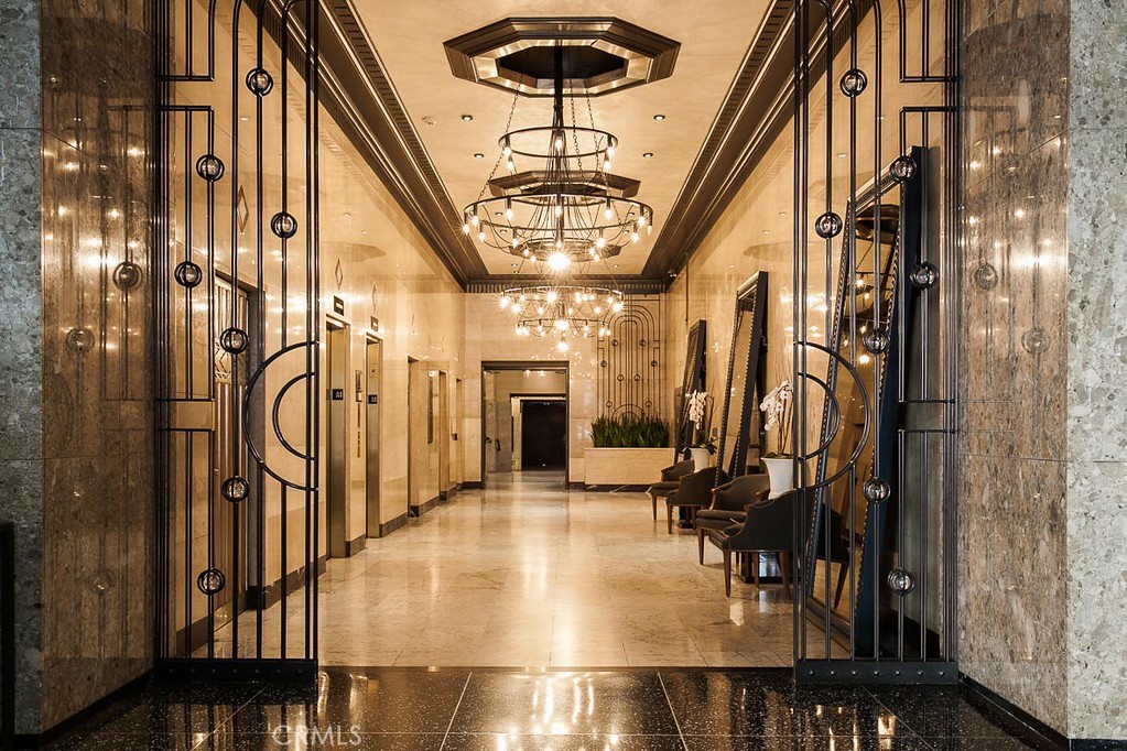 460 South Spring Street, Unit 1013 Los Angeles, CA 90013 - Photo 21 of 25 a view of a hallway with a chandelier