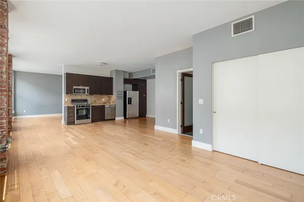 a view of a kitchen with a microwave and furniture
