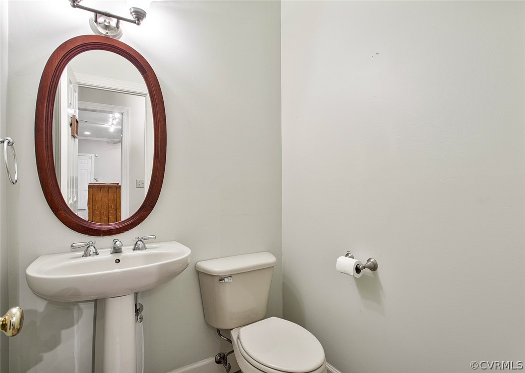 4019 Belspring Road Chester, VA 23831 - Photo 19 of 46 a bathroom with a sink a mirror and a toilet