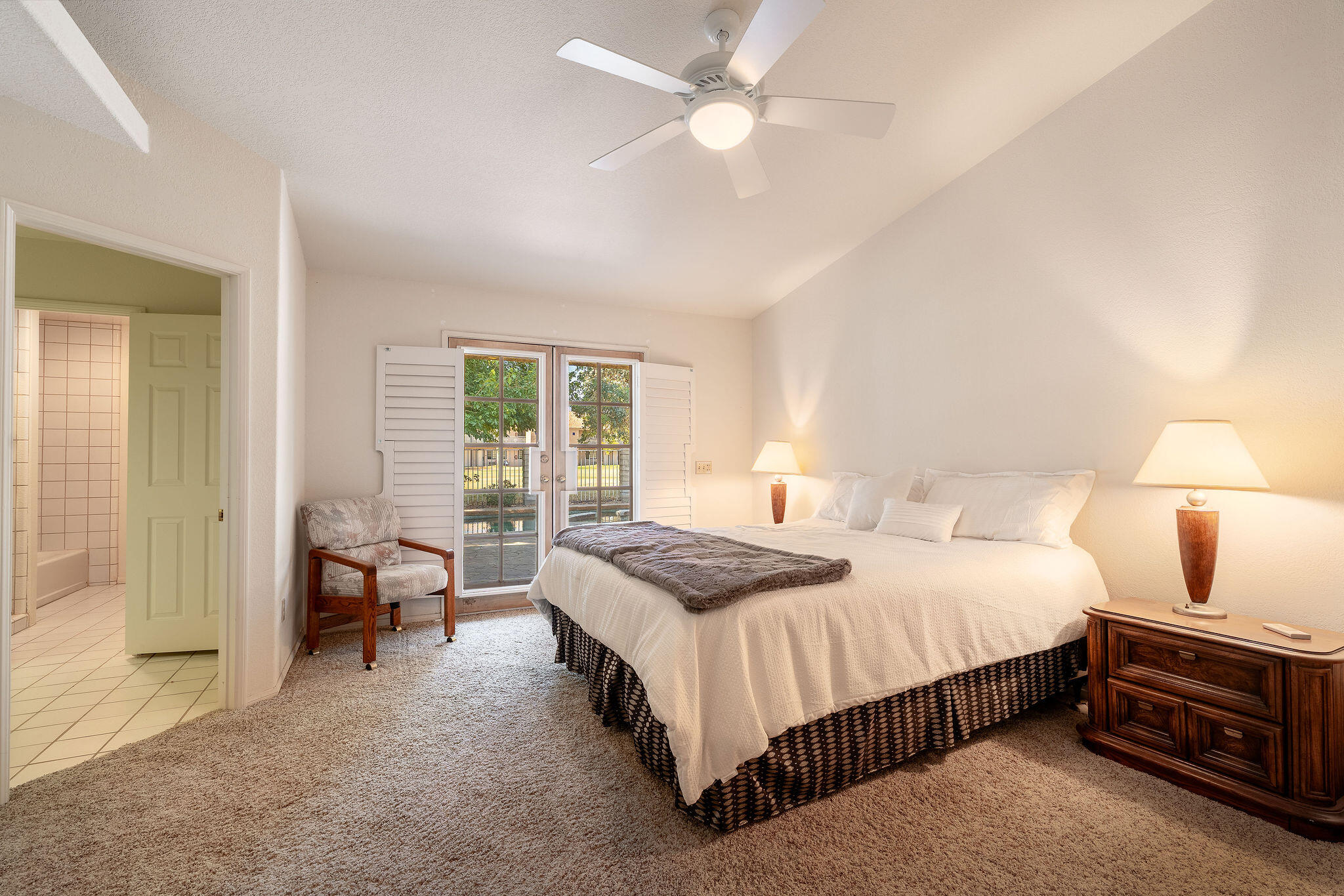 82151 Hanson Drive Indio, CA 92201 - Photo 15 of 38 a bedroom with a bed and a chandelier