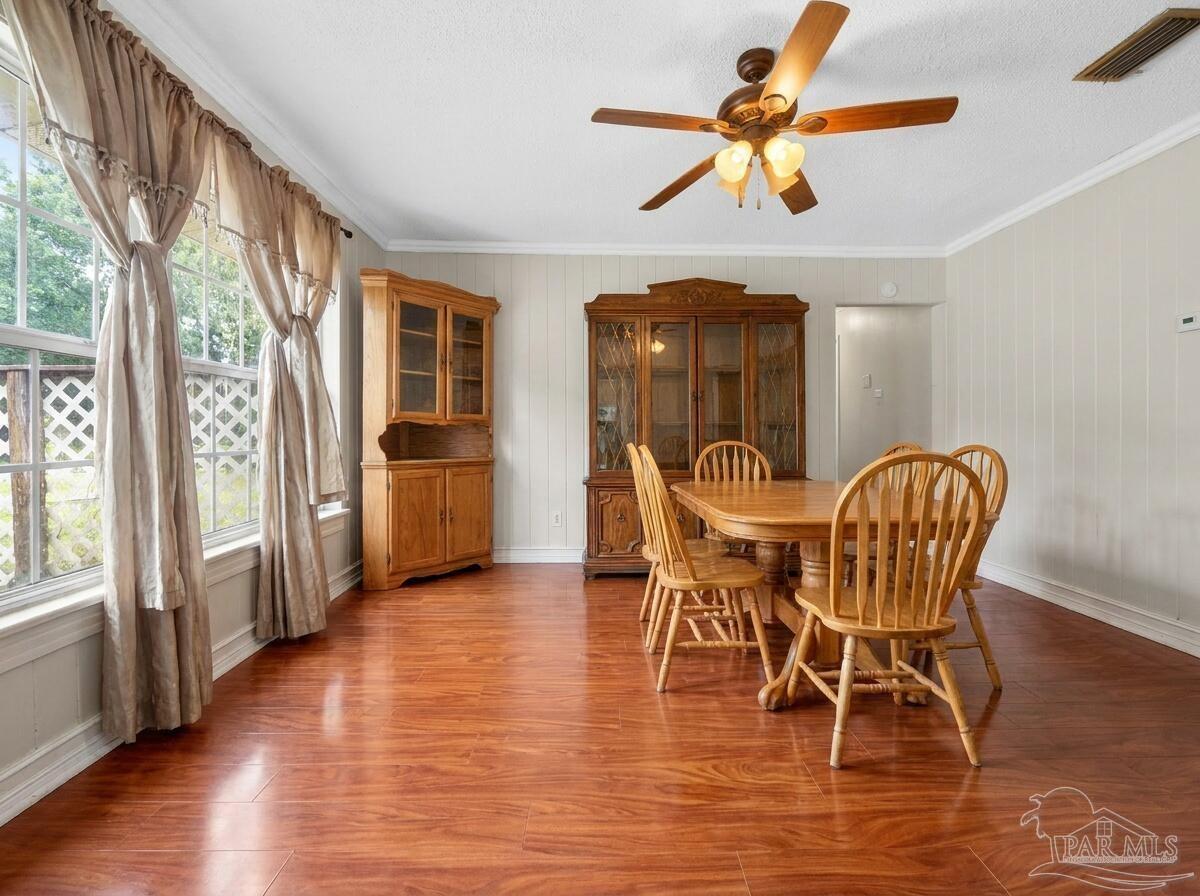 6253 Allentown Road Milton, FL 32570 - Photo 5 of 31 a view of a dining room with furniture window and wooden floor