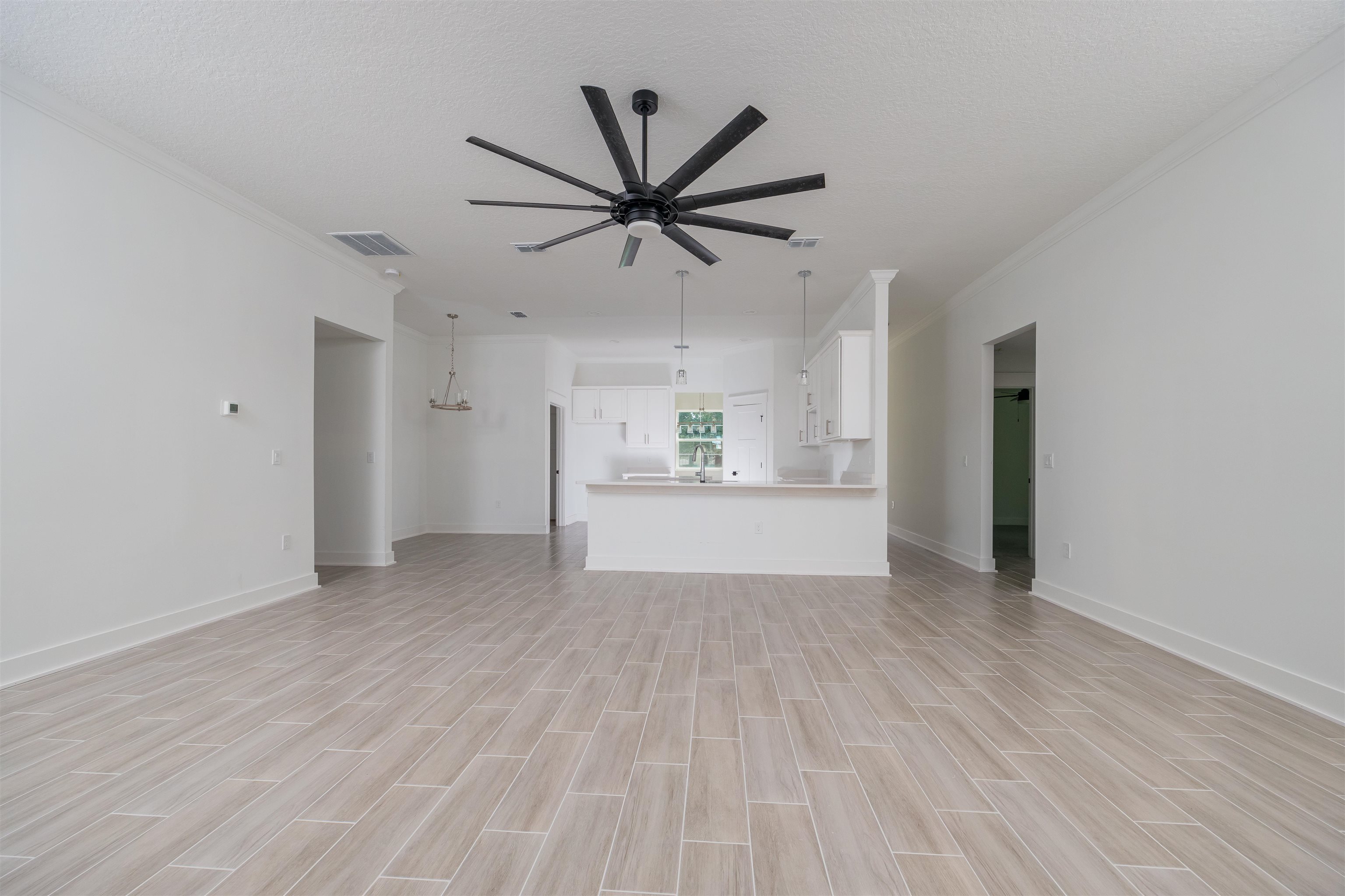 1130 Prince Road St. Augustine, FL 32086 - Photo 6 of 48 a view of a livingroom with a ceiling fan & wooden floor