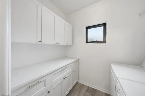 a view of storage and utility room with closet