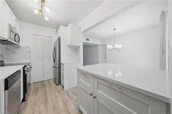 a spacious bathroom with a granite countertop sink a toilet a large mirror and shower
