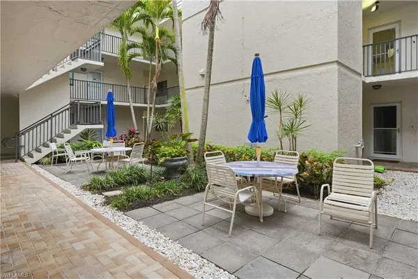 a outdoor space with the couches and a potted plant on the table