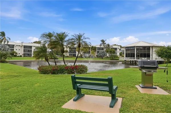 a garden view with a bench and lawn chairs