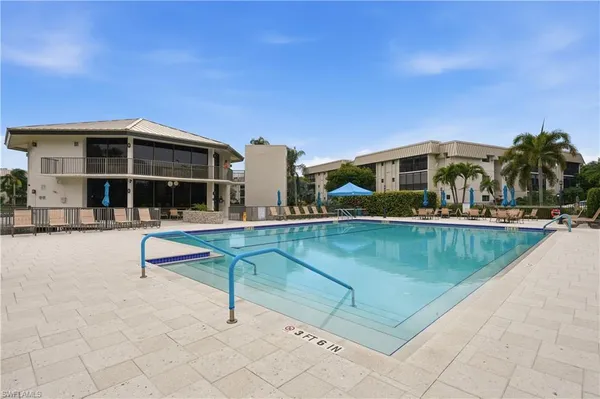 a swimming pool with outdoor seating and yard