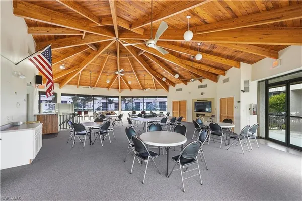a living room with furniture a rug and a large window