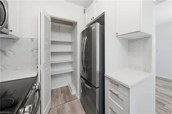 a view of walk in closet with empty racks