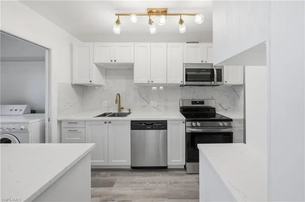 a kitchen with a stove and a microwave