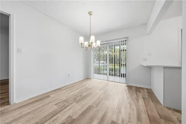 a view of a room with wooden floor water heater and a window