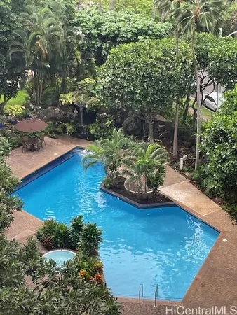 a view of a backyard with plants and a patio